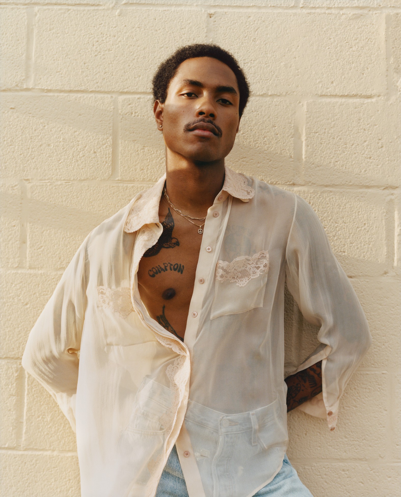 Steve Lacy standing in a white shirt. 