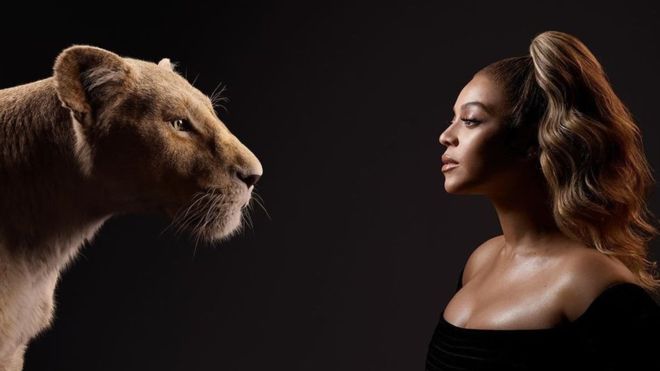 Beyonce stands in fron of a black background, wearing a black shirt. Beyonce is staring at a female lion.
